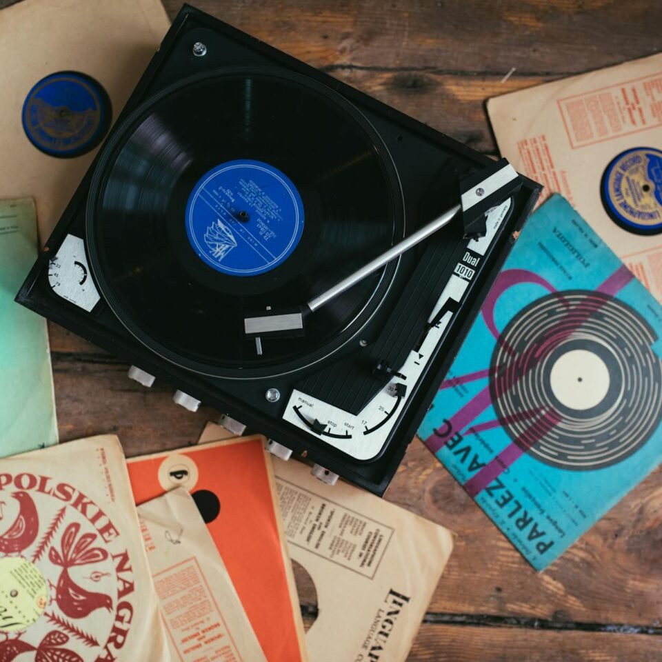 vinyl records and turntable on wooden floor
